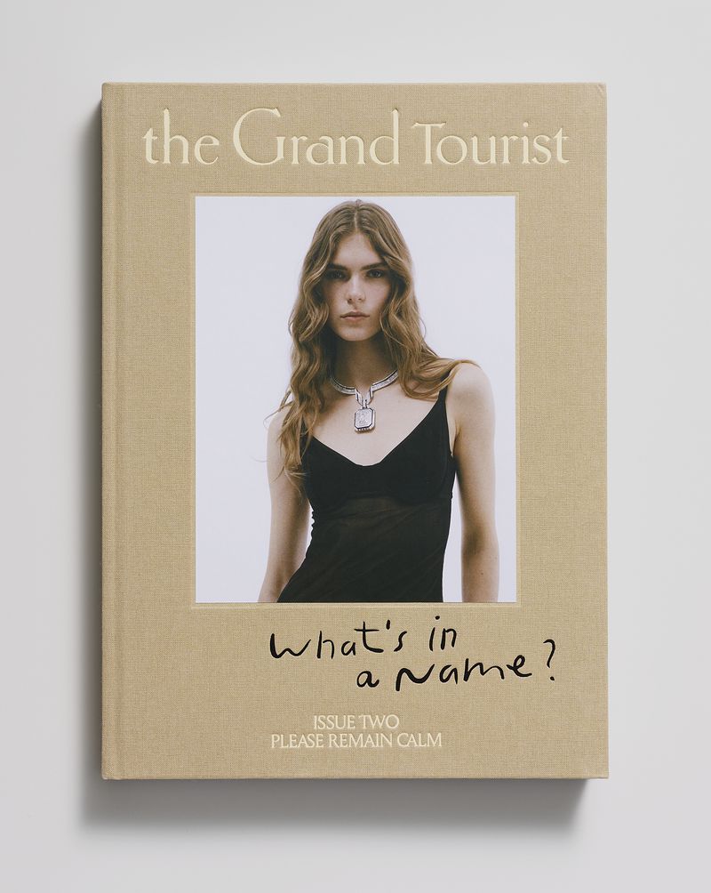 The Grand Tourist Issue Two book cover featuring an inset portrait of Anna Robinson wearing a statement necklace and black dress.