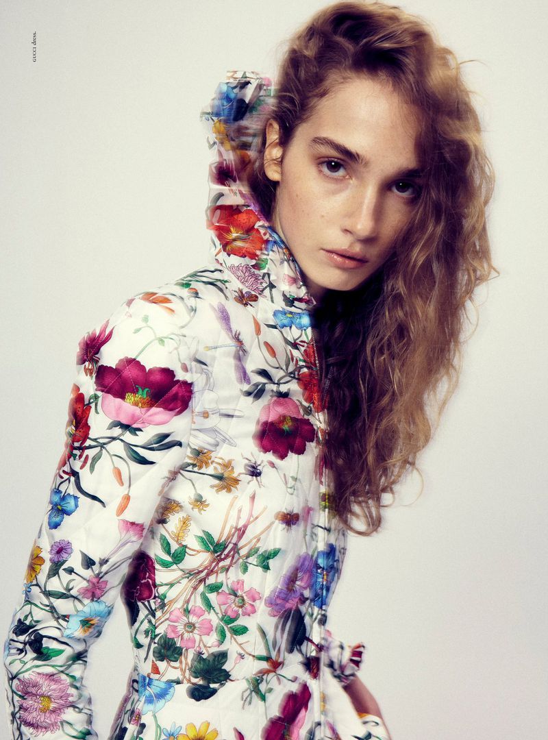 Model Audrey Lees wearing a floral quilted high-collar jacket against a white studio background for Russh.