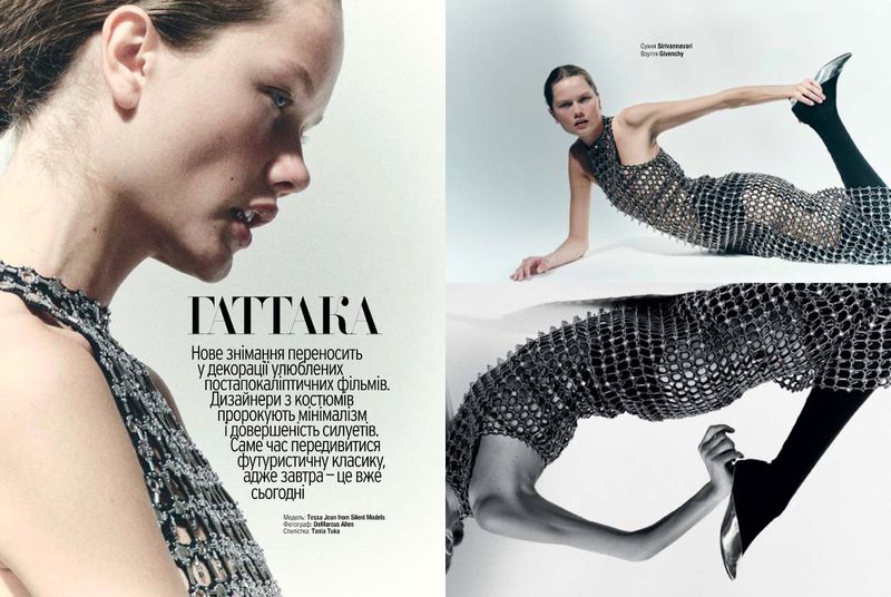 Fashion editorial shot featuring a woman in a metallic dress in a studio, lying on a white surface, showcasing a futuristic style.
