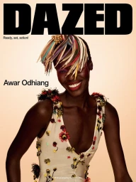 Model Awar Odhiang smiling on the cover of Dazed Magazine wearing an embroidered cream top and a colorful fringe headpiece.