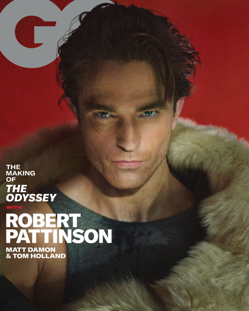 Robert Pattinson wearing a fur-trimmed coat and dark tank top against a red backdrop on the cover of GQ Magazine.