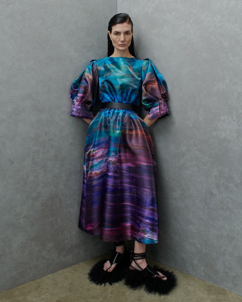 Model Eliana Weirich wears an abstract teal and purple puff-sleeve midi dress and black feathered sandals for Roksanda SS26.