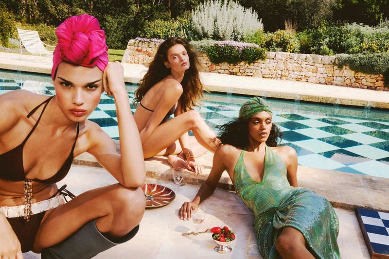 Three models posing by an outdoor swimming pool for a Zara fashion campaign photographed by Carlijn Jacobs.
