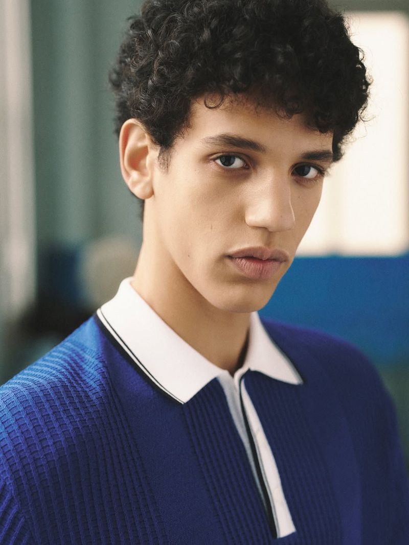 Model Ezaim Cabo wearing a blue textured knit polo shirt with a contrasting white collar for A.P.C. Golf.