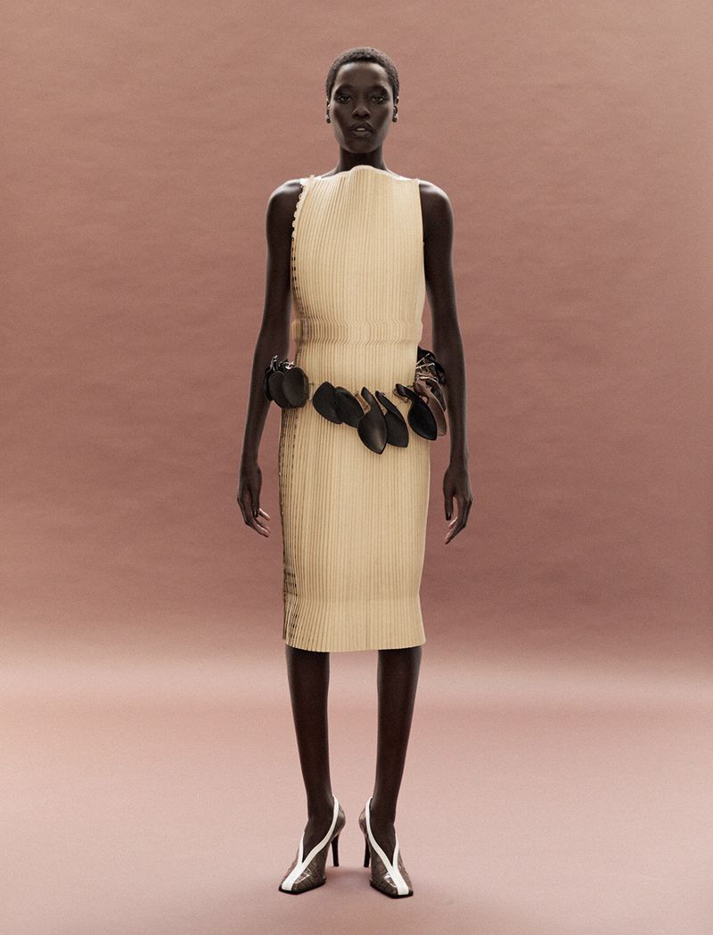 Model Awar Odhiang in structured beige dress with waist pouch belt by Dazed Magazine, shot by Carlijn Jacobs.