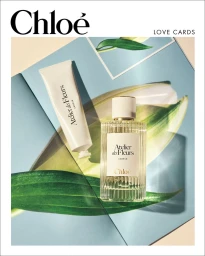 Chloé Atelier des Fleurs perfume bottle and cream tube arranged over botanical prints in bright sunlight.