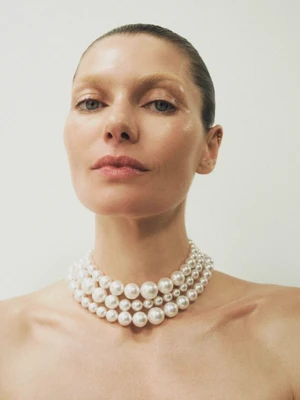 Close-up portrait of model Jessica Hart wearing a multi-strand pearl choker necklace for Harper's Bazaar Australia.