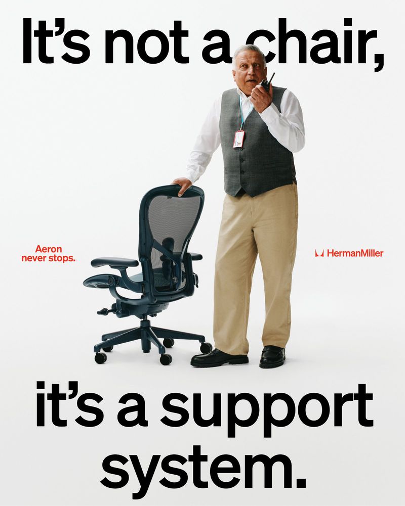 An elderly man holding a walkie-talkie stands beside an ergonomic office chair against a plain white background with bold black typography.