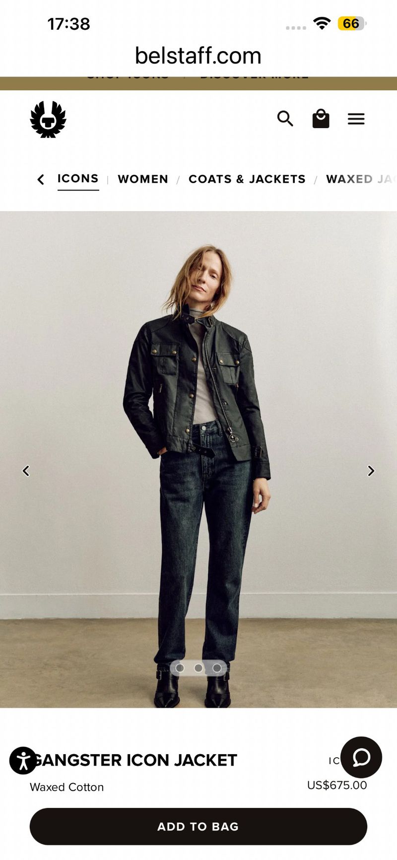 Model Lindsay Sullivan posing in a black waxed cotton jacket and dark jeans against a neutral wall.