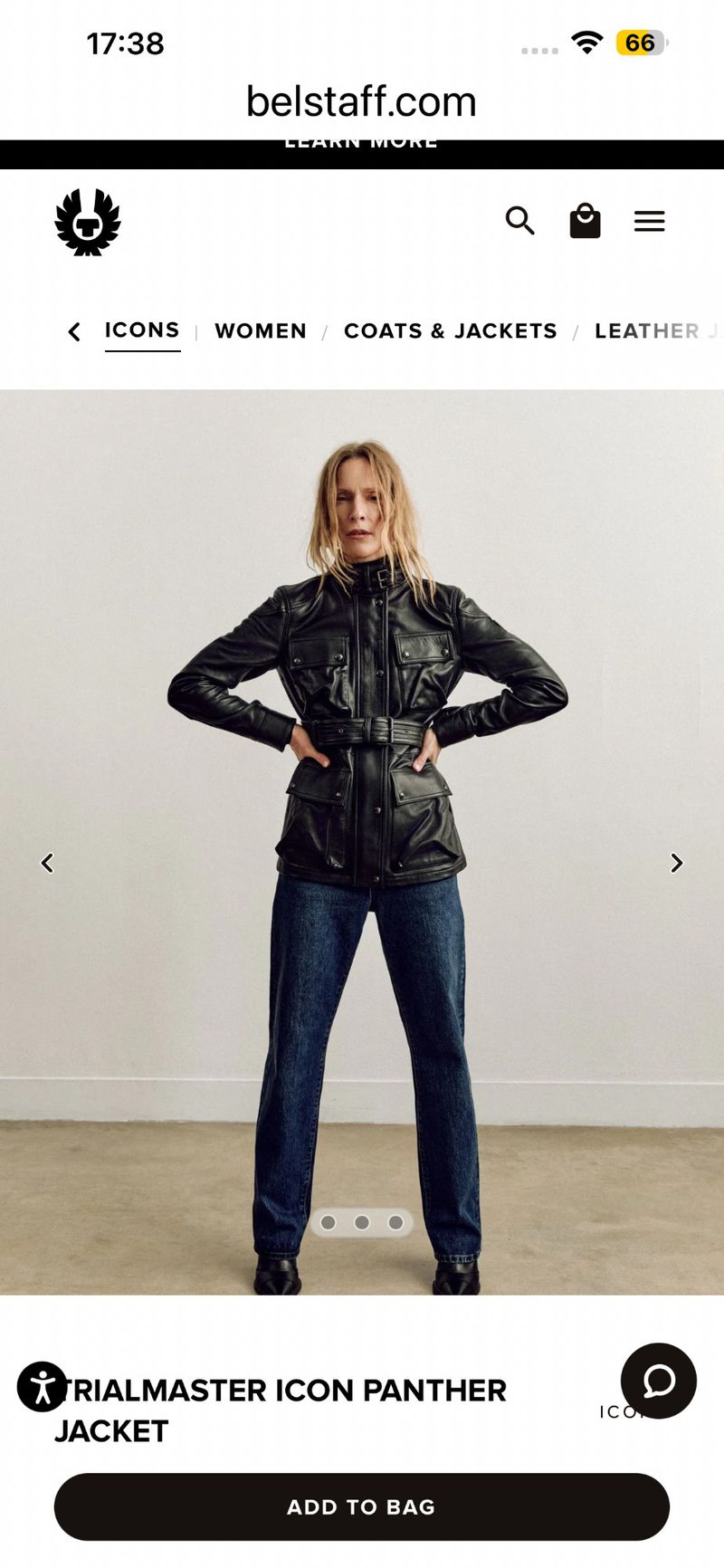 Model Lindsay Sullivan posing in a black belted leather jacket and blue denim jeans for Belstaff.
