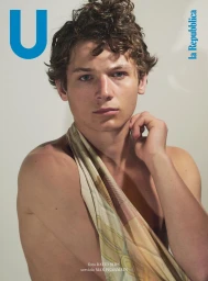 Portrait of young curly-haired man draped in printed fabric for U Repubblica project