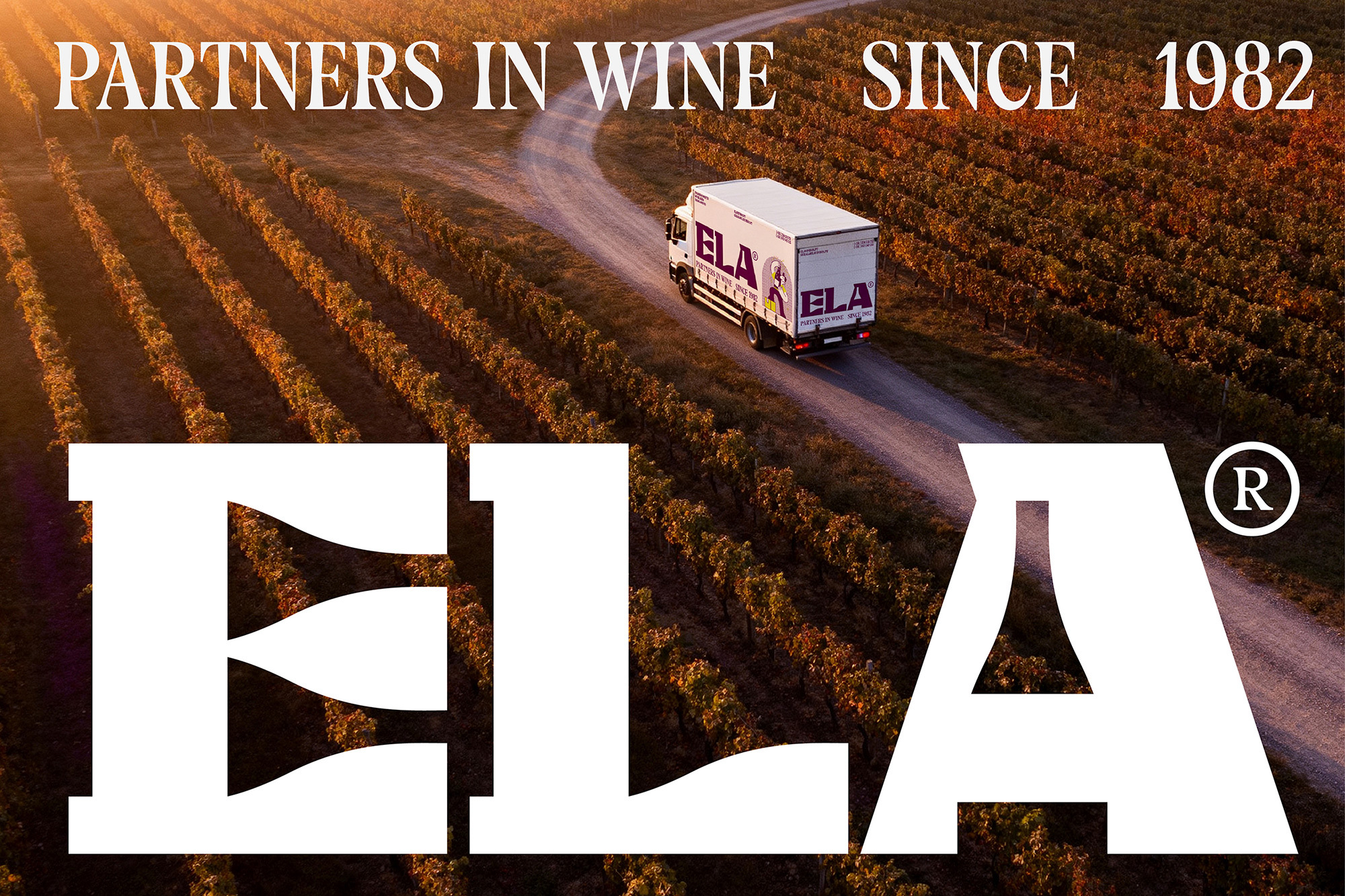Aerial view of a white delivery truck driving along a vineyard road with large white ELA typography overlay.