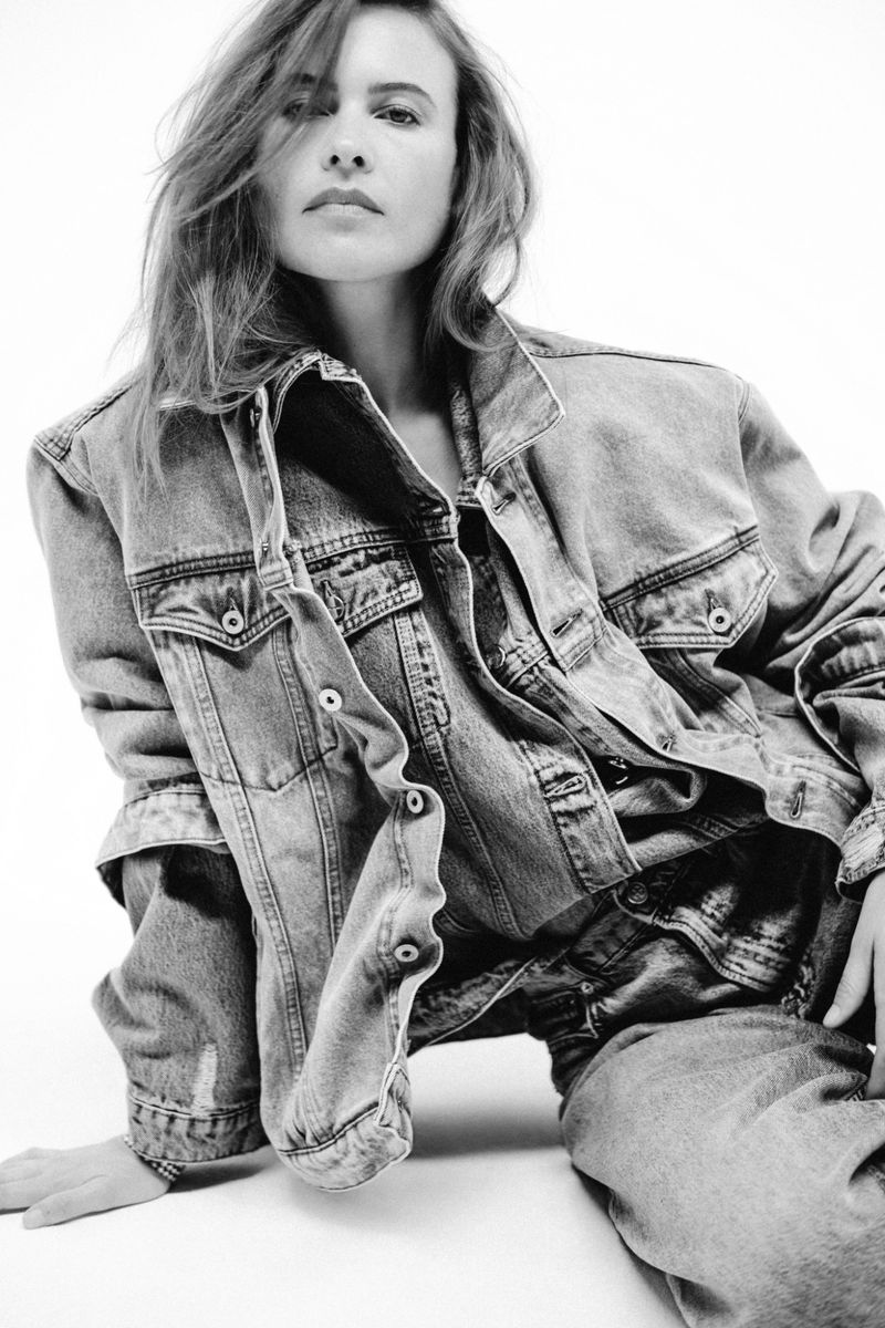 Model Behati Prinsloo wearing a denim jacket and jeans against a plain white background for M Revista de Milenio