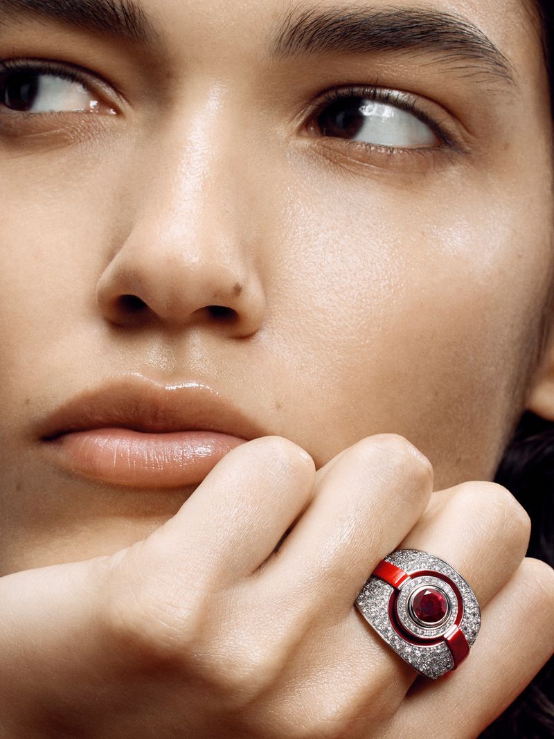 Close-up portrait of a model resting chin on hand, wearing a diamond and red enamel ring for The Sunday Times Style Magazine UK.