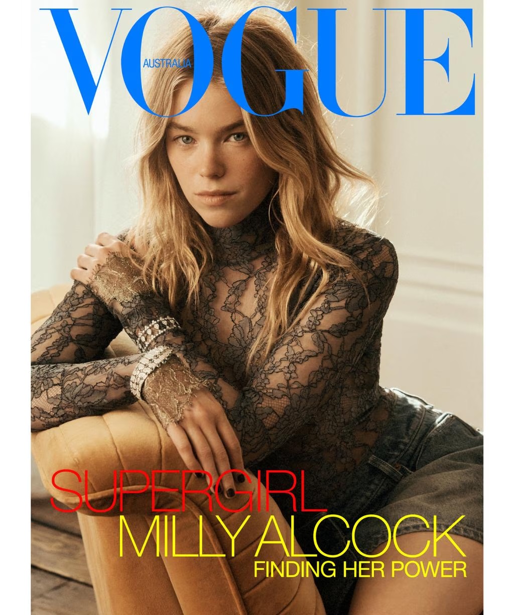 Milly Alcock wearing a black lace turtleneck and jeweled bracelets seated on a tufted chair for Vogue Australia.