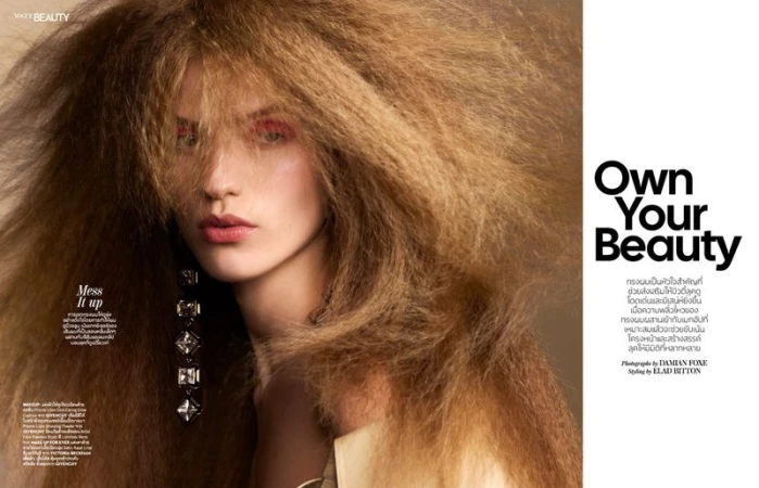 Model with voluminous crimped blonde hair and pink eyeshadow for Vogue Thailand, photographed by Damian Foxe