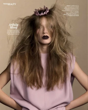 Model Carolina Mendillo with teased messy hair, dark lipstick, and a pink sleeveless top for Vogue Thailand.