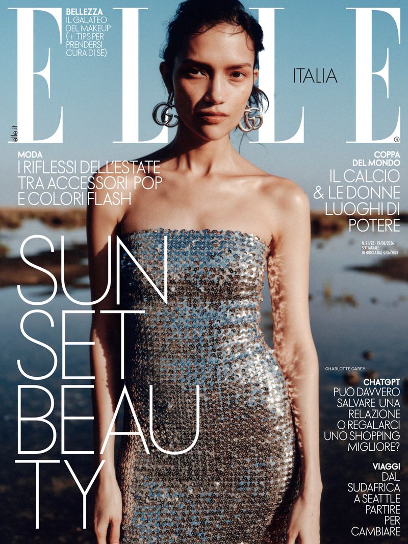 Charlotte Carey wearing a strapless silver sequined dress and logo earrings on an Elle Italia magazine cover.