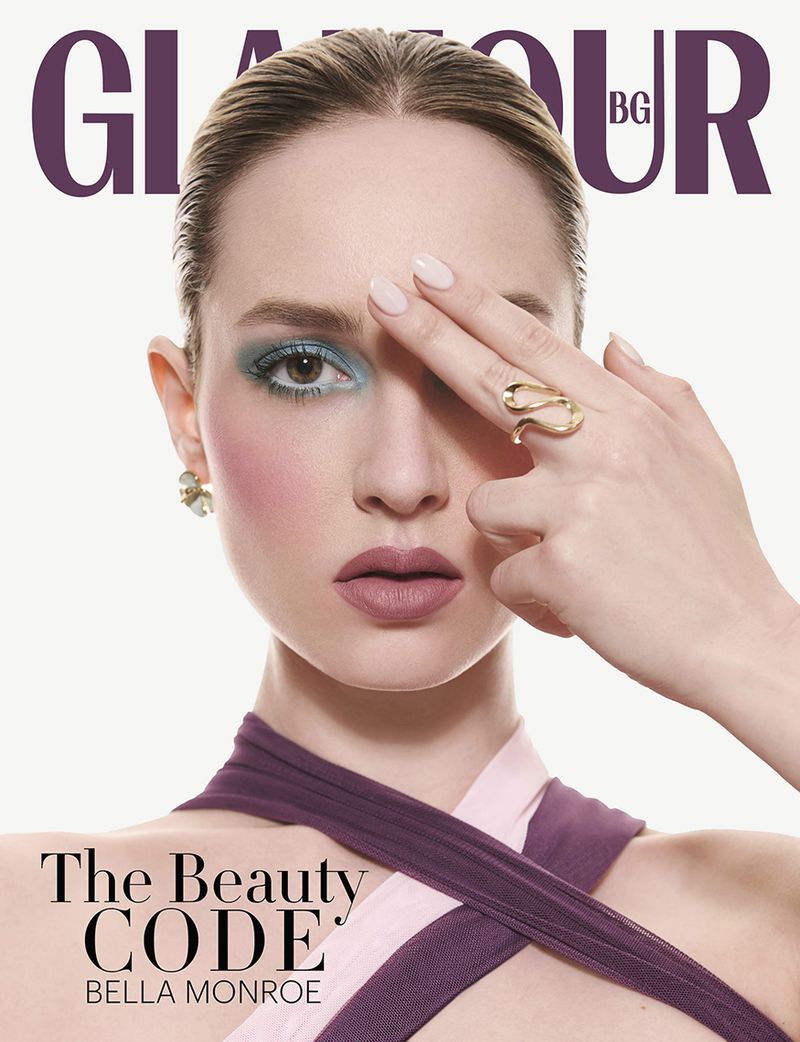 Glamour Bulgaria magazine cover featuring a woman with blue eyeshadow and a gold ring holding her hand across her face against white.