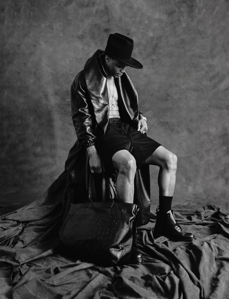 Russell Westbrook wearing a black fedora and leather coat seated against a textured backdrop for Numero Netherlands
