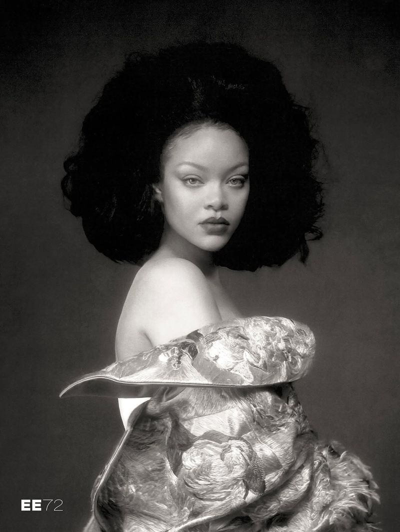 Monochrome portrait of Rihanna with voluminous bouffant hair wearing an off-the-shoulder floral brocade garment.