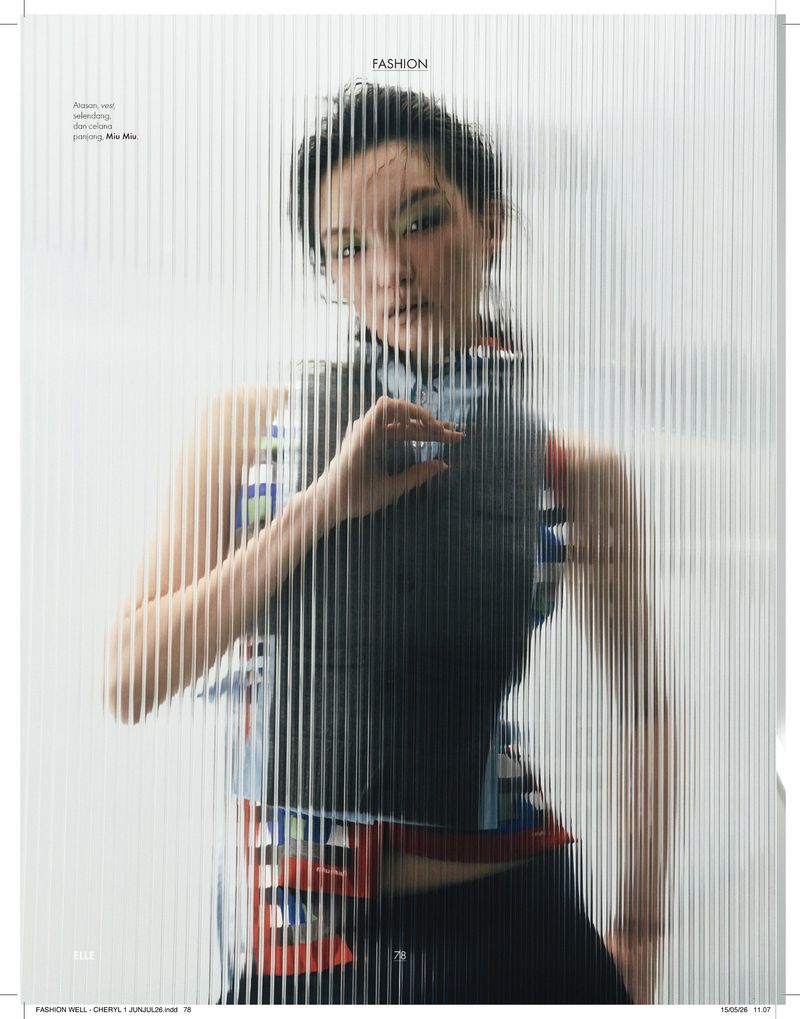 Model Shinyu Pan posed behind vertical reeded glass wearing a patterned vest top for an Elle Indonesia magazine editorial.