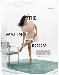Model Shinyu Pan in a structured pale blush outfit posing on a green rug in a minimalist studio set for Elle Indonesia.