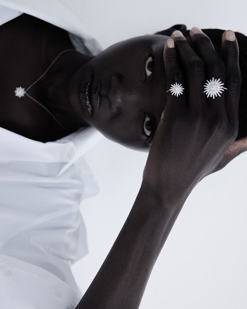 Model Anyiel Majok wearing diamond rings and necklace in a white studio setting for Amica magazine editorial Oro Puro.
