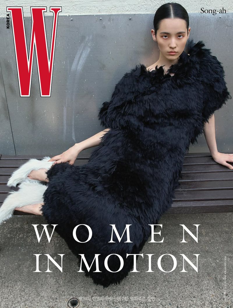 Model Song Ah Woo reclining on a bench in a black textured feathered dress for the W Korea magazine cover.