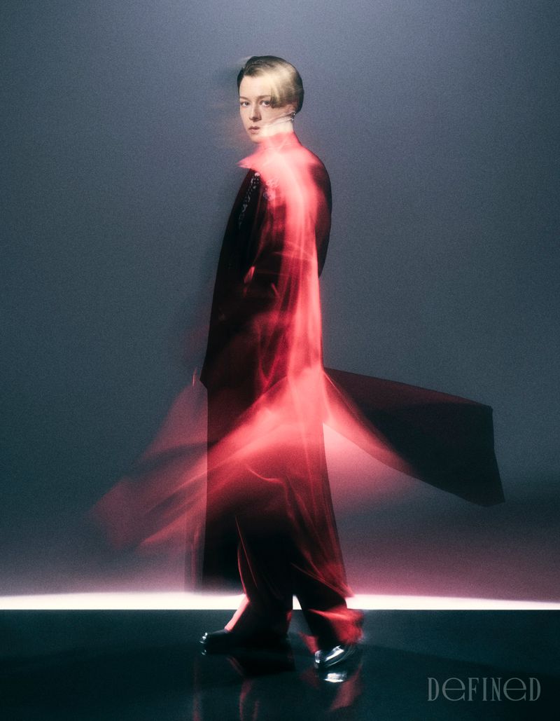 Portrait of Emma D'Arcy with long-exposure red motion blur against a dark studio background for DEFINED Magazine.