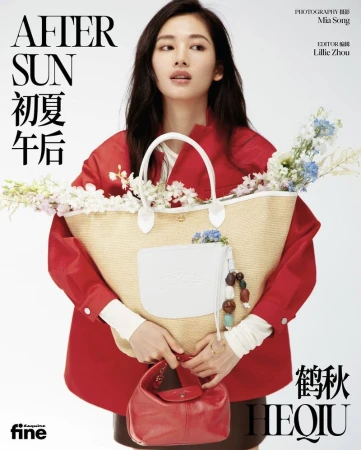 Asian woman in red jacket and straw tote bag with flowers poses indoors for magazine cover; beauty and fashion editorial style.