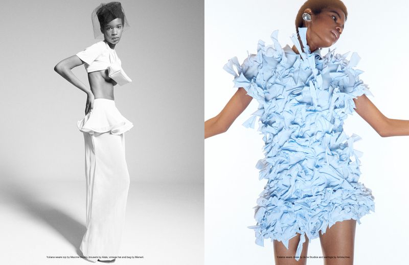 Fashion editorial shot of two women in avant-garde dresses in studio, one in white two-piece with hat and one in light blue.