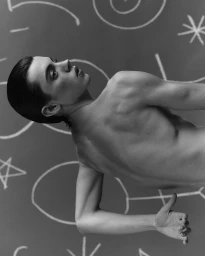 Portrait of a model against a dark background with chalk drawings featuring Jordan Drysdale photography.