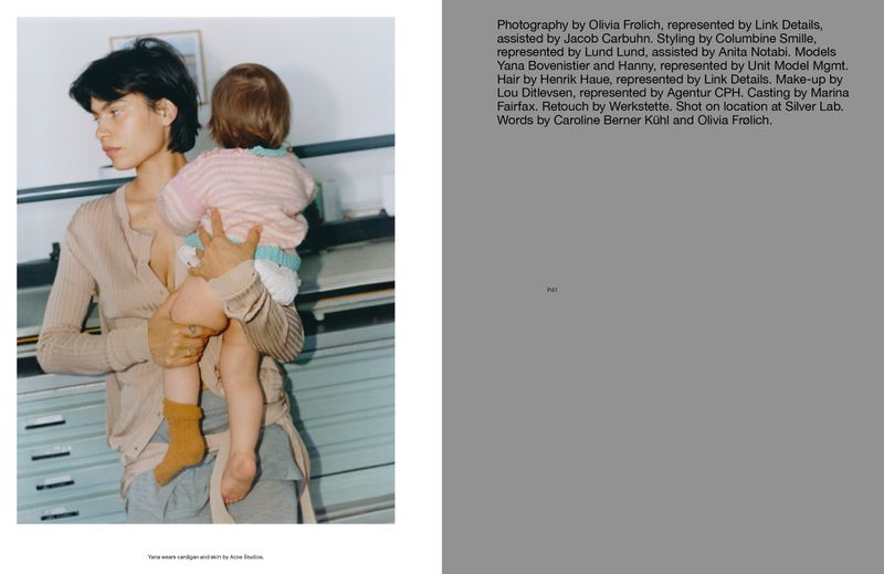 A mother holds her child in a casual indoor setting, captured in a soft, natural light. The scene reflects a candid, lifestyle moment.