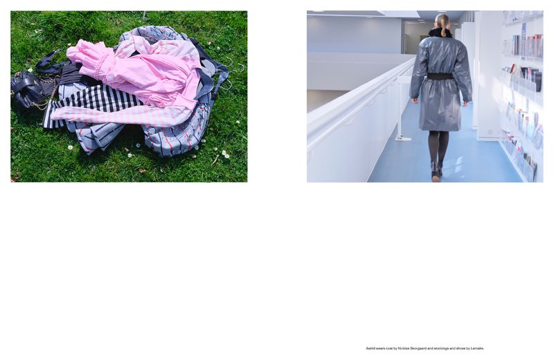 Clothing pile on grass with pink shirt, black purse. Woman in gray coat walks in white hallway with magazine rack and blue floor.