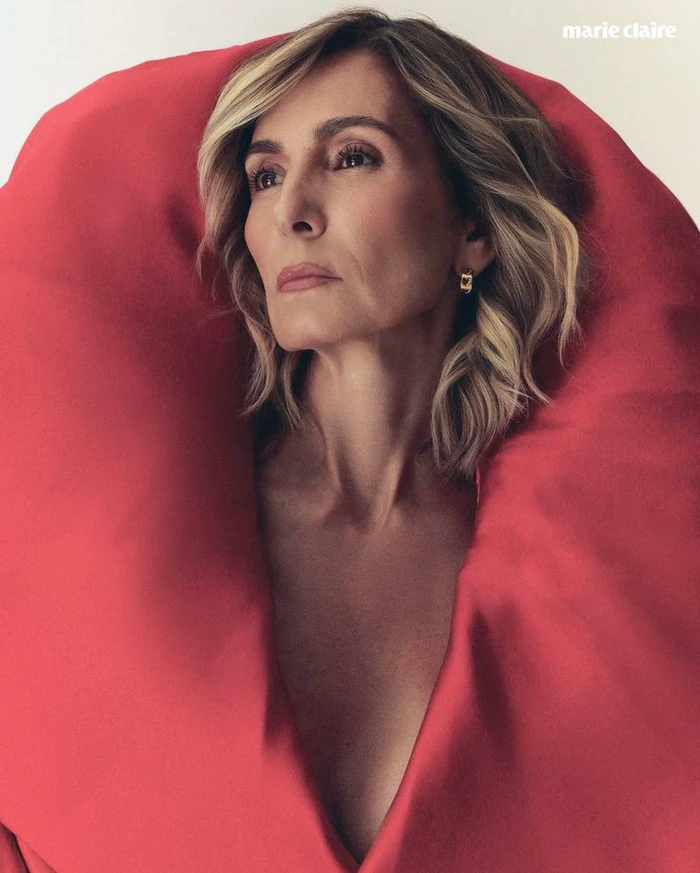 Portrait of a woman framed by an oversized sculptural red collar against a white background for Marie Claire Mexico.