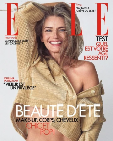 Magazine cover featuring a smiling mature woman with graying hair wearing a light-brown corduroy shirt, against a white backdrop with text.