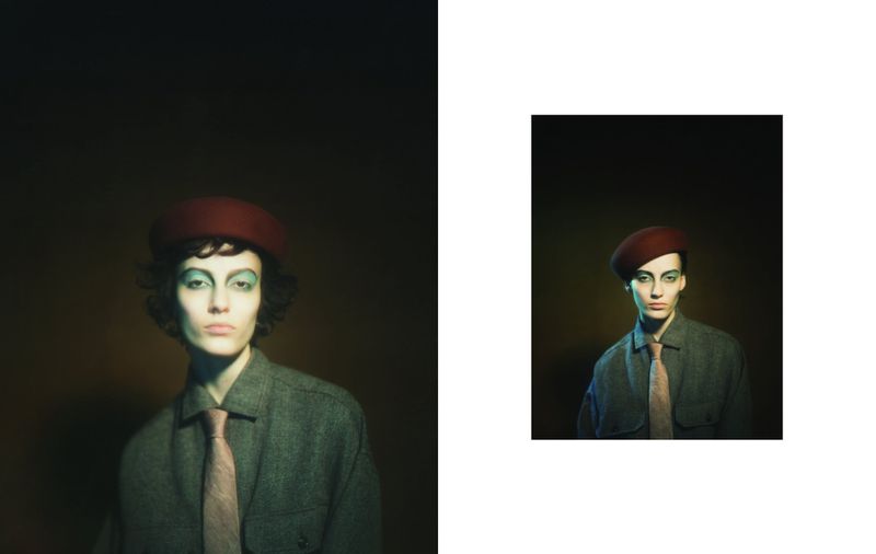 Studio portrait of a person wearing a beret, makeup, shirt and tie, with a dark background and dramatic lighting, evoking a vintage feel.