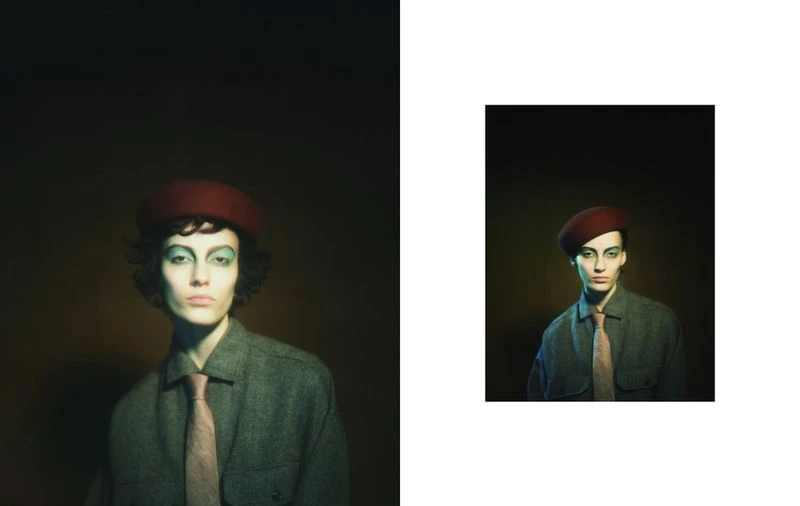 Studio portrait of a person wearing a beret, makeup, shirt and tie, with a dark background and dramatic lighting, evoking a vintage feel.
