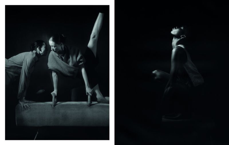 Monochrome studio shot of two women on a gymnastics vault horse and a single woman standing in a dark setting, high contrast, artistic.