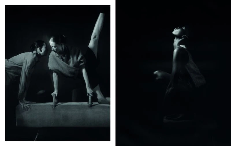 Monochrome studio shot of two women on a gymnastics vault horse and a single woman standing in a dark setting, high contrast, artistic.
