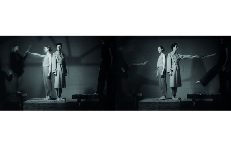 Monochromatic fashion shot featuring three women in neutral pantsuits and trench coats, posing in a photo studio with surreal visual effects.