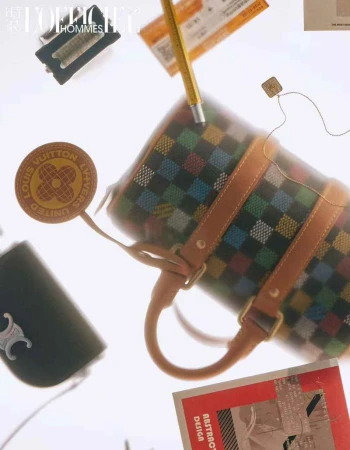 Overhead shot of a barrel bag featuring a colorful checkered pattern, complemented by a leather logo tag and other fashion accessories.