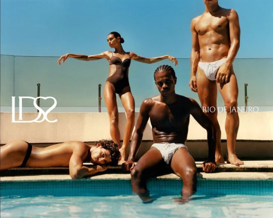 Four models posing poolside under a clear blue sky for Ludovic de Saint Sernin swim fashion campaign
