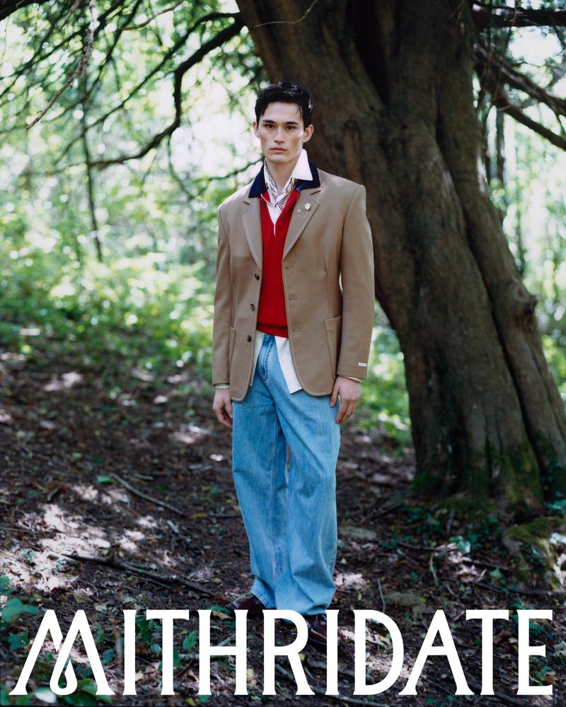 Alex Schlab poses in a woodland setting wearing a beige blazer and wide-leg denim for the Mithridate Pre Fall 26 campaign.