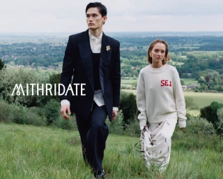 Two fashion models walking down a grassy hill overlooking a vast rural valley in the Mithridate Pre Fall 26 campaign.