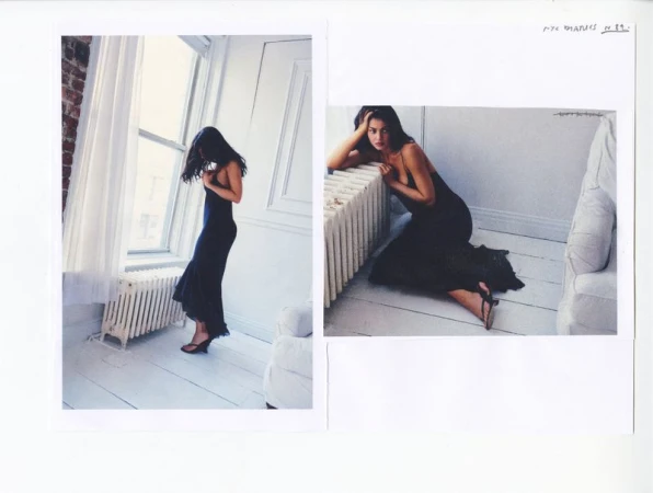 Kylie Jenner wearing a black slip maxi dress and strappy heels in two editorial photographs set inside a bright white room.
