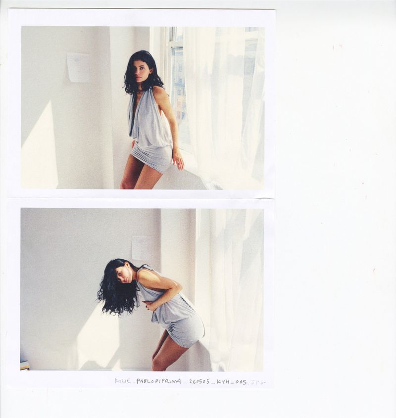 Kylie Jenner wearing a draped grey minidress posing beside a bright window with sheer curtains in two stacked test prints.