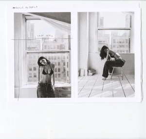 Black and white contact sheet diptych of Kylie Jenner in a bikini top and denim jeans posing by large loft windows.