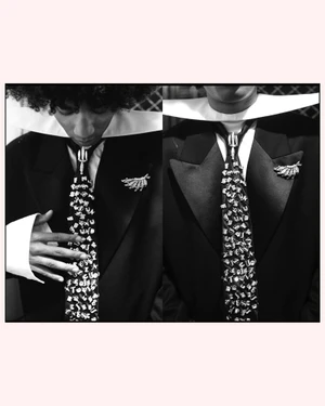 Black and white split view of a model wearing a tuxedo jacket, an exaggerated wide wing collar, and an embellished necktie.